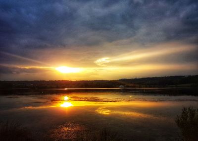 Scenic view of lake against sky during sunset