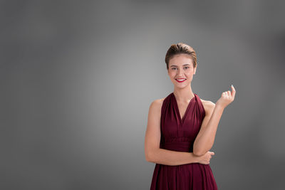 Portrait of young woman against white background