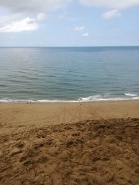 Scenic view of beach against blue sky