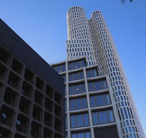 Low angle view of modern building against clear blue sky