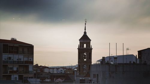 Buildings in city against sky during sunset