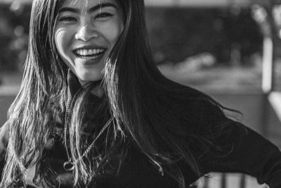 Portrait of smiling young woman standing outdoors