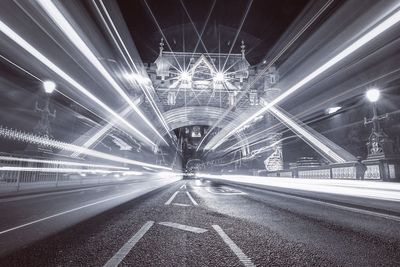 Light trails on tower bridge in city at night