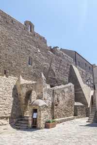 Low angle view of old building against clear sky