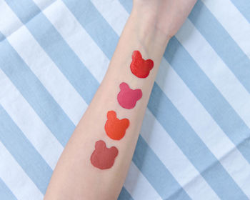 Close-up of woman holding heart shape on hand