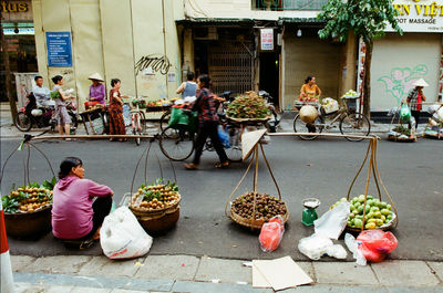Group of people for sale at market stall