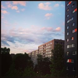 Buildings against cloudy sky