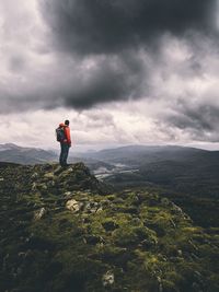 Man standing on mountain against sky