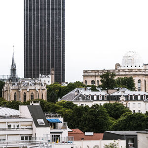 Buildings in city against clear sky