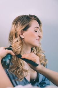 Portrait of a smiling young woman holding camera