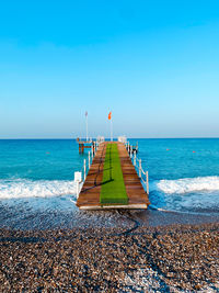 Scenic view of sea against clear blue sky