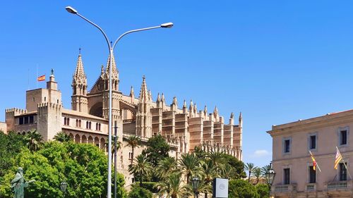 Low angle view of building against clear blue sky