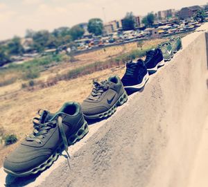 High angle view of shoes on sand at beach against sky