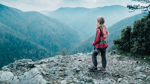 Full length of man standing on mountain against sky