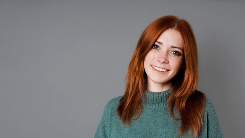 Portrait of young woman against white background