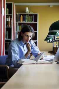 Young man studying in library