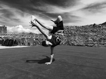 Man breakdancing on stage against sky