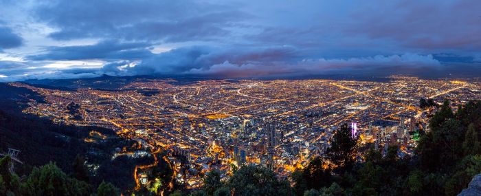 High angle view of illuminated cityscape against sky