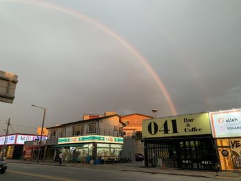 Scenic view of rainbow over building against sky