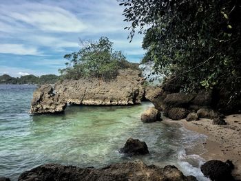 Scenic view of sea and rocks against sky