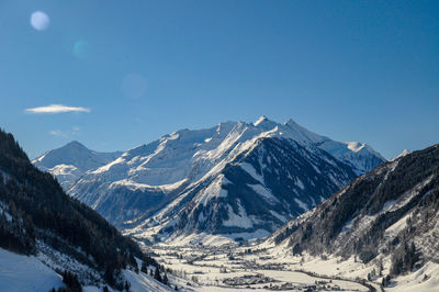 Scenic view of snowcapped mountains against clear sky