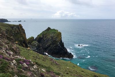 High angle view of cliff by sea against sky