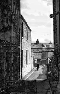 Man in city against sky