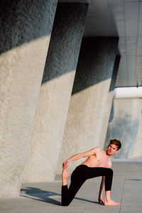 Full length of man leaning on wall