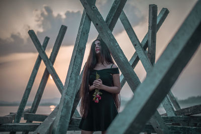 Portrait of woman standing against sky