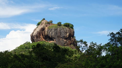 Low angle view of rock formation against sky