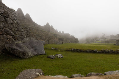 Scenic view of rocks on field against sky