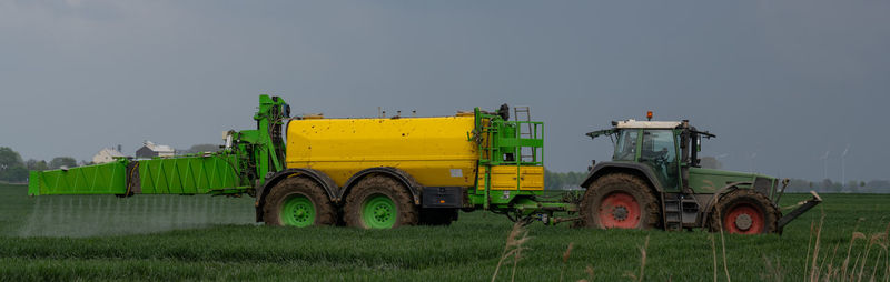 Tractor with field sprayer when applying pesticide against pesticide