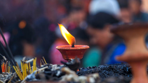 Close-up of lit candles in temple