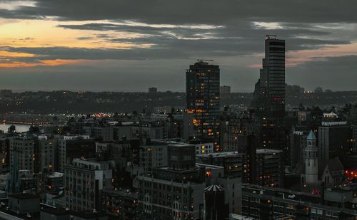 Cityscape against cloudy sky