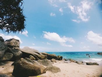 Rocks on beach against sky