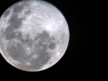 Low angle view of full moon against sky at night