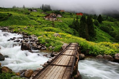 Scenic view of river amidst mountains against sky