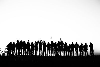 Silhouettes of people in row