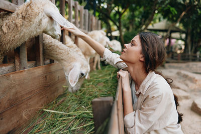 Side view of young woman with horse