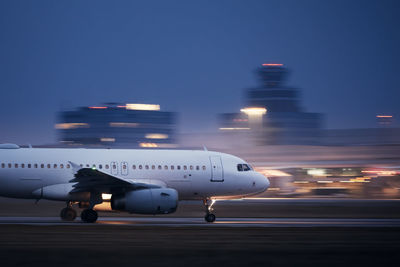 Airplane on airport runway at night