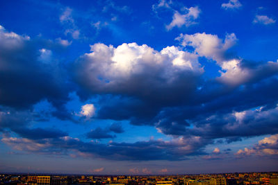 Aerial view of city against blue sky