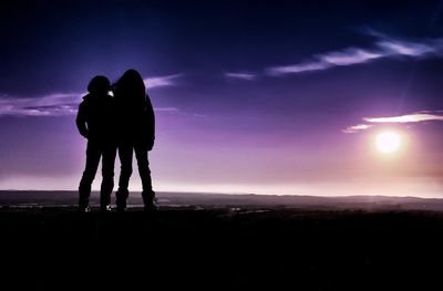 Silhouette of people standing on landscape