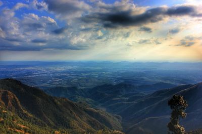 Scenic view of mountains against cloudy sky