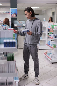 Portrait of young man standing in office