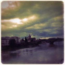 Buildings against cloudy sky