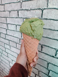 Midsection of person holding ice cream outdoors