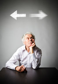 Full length of a man sitting on wall