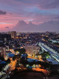 High angle view of illuminated buildings against sky at sunset