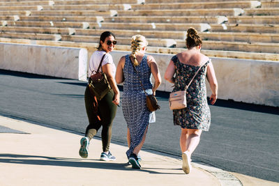 Full length of young women walking in city