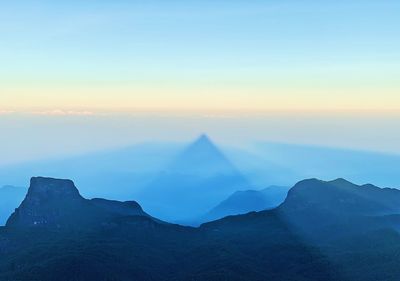 Scenic view of mountains against sky during sunset